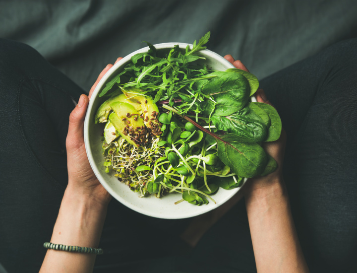 Woman holding salad with arugula