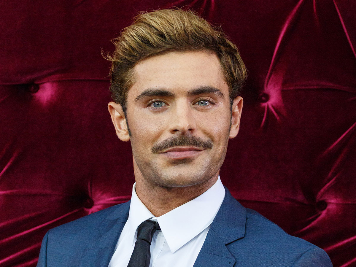 zac efron blue suit red carpet facial hair