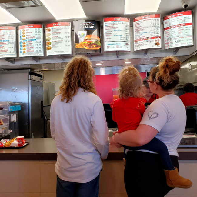 family looking at wendy's menu