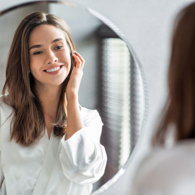 woman smiling in mirror