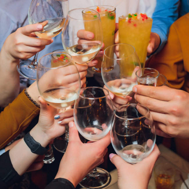 people cheersing glasses of wine and beers