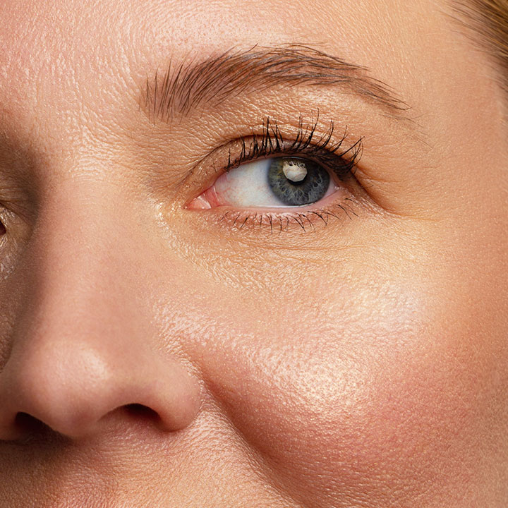 closeup blue eyed woman skin fine lines wrinkles