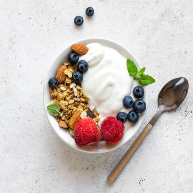 bowl of greek yogurt with berries and granola