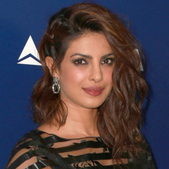 priyanka chopra striped top sheer brown wavy hair side part asymmetrical lob haircut red carpet dangly earrings