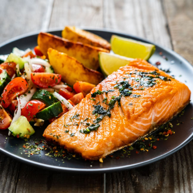 salmon on a plate with veggies