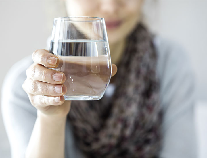 Woman holding a glass of water