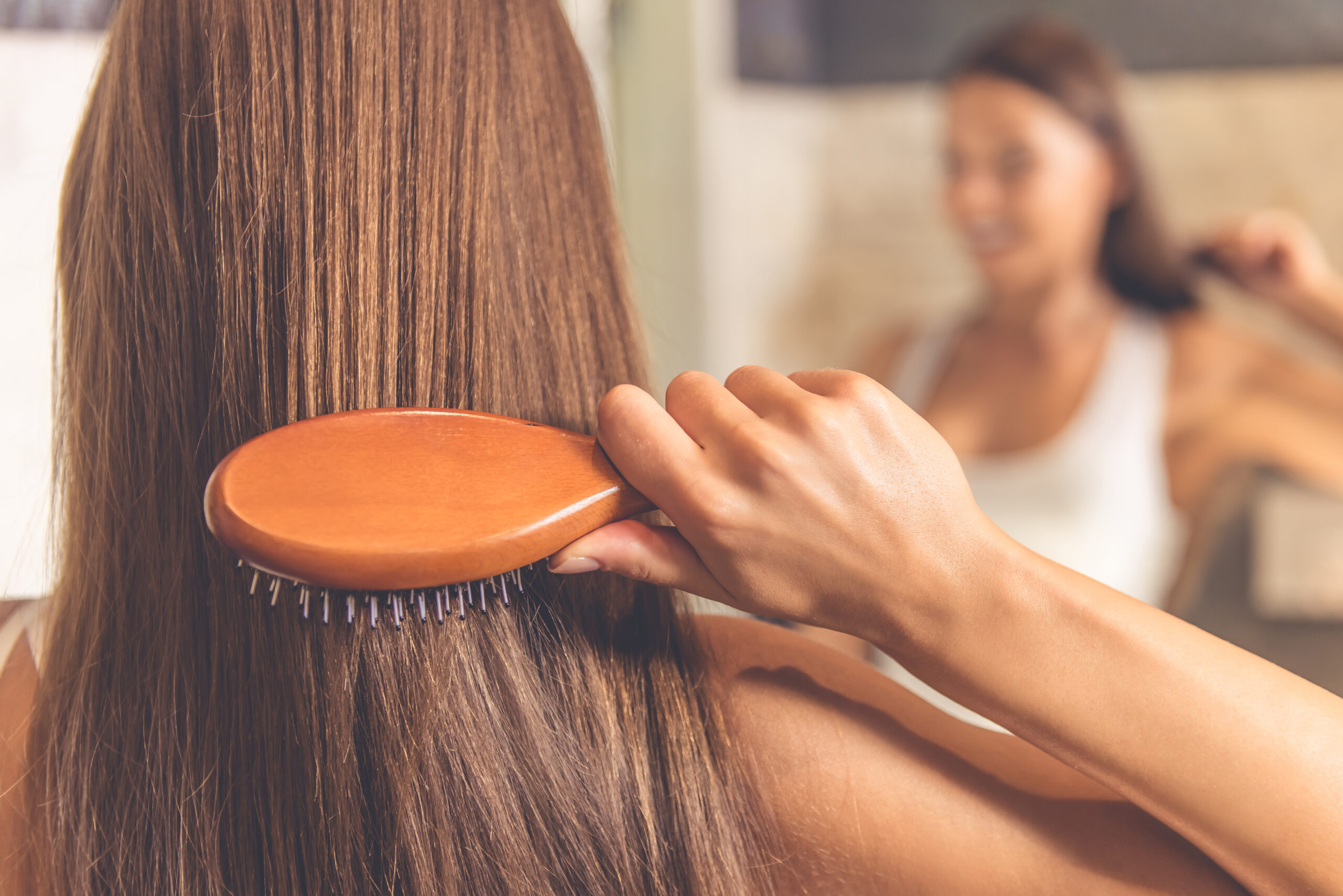 Person brushing hair.