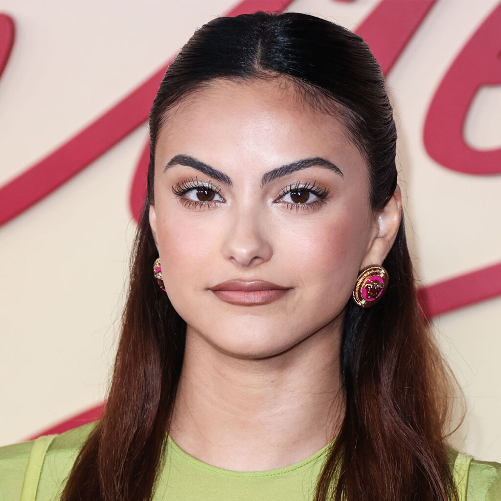 Camila Mendes Embraces The No Pants Trend In A Black Sweater And