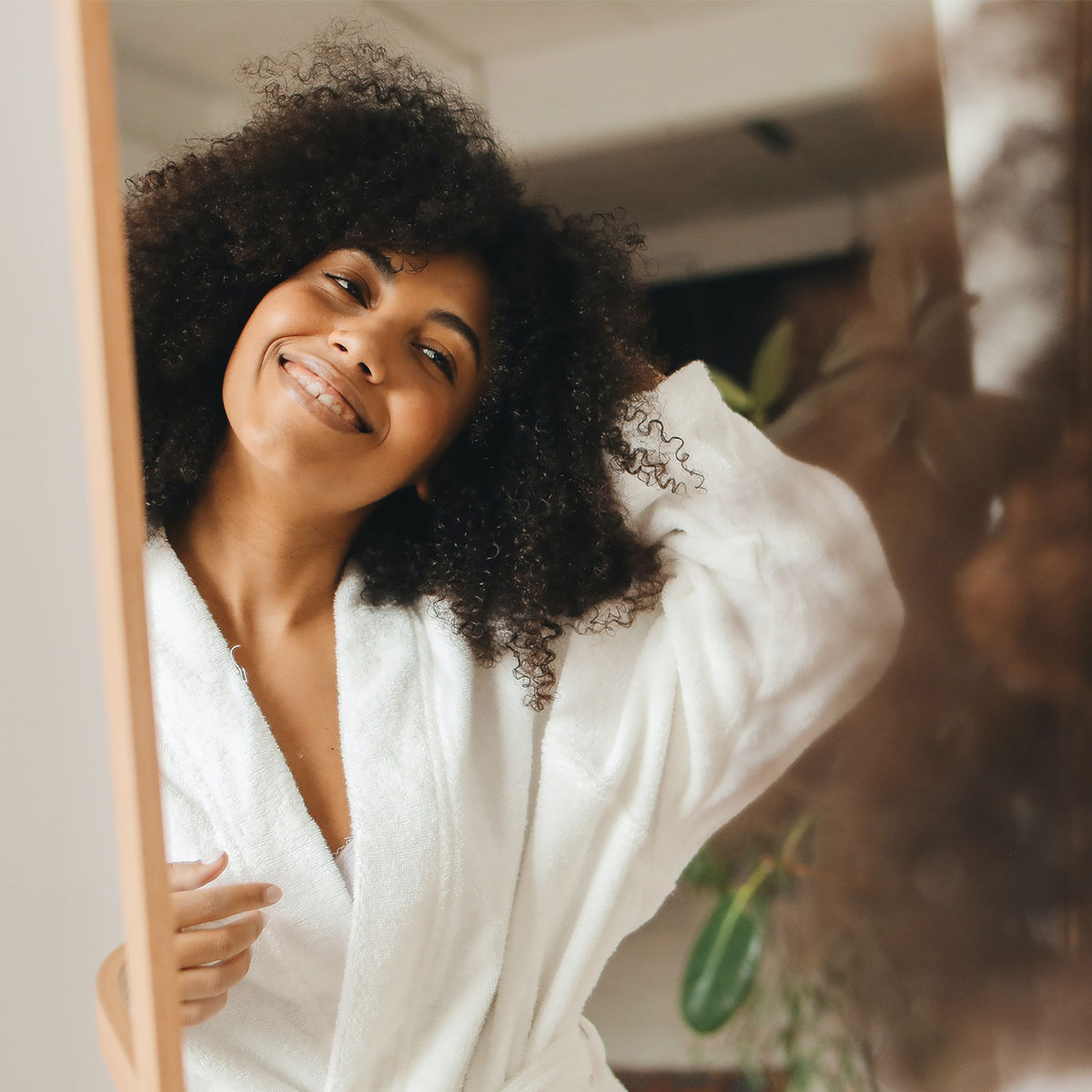 happy woman smiling in the mirror