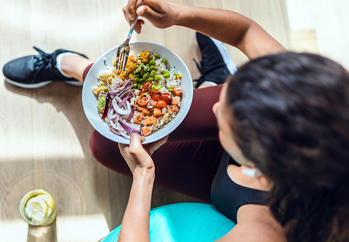 Woman eating a salad.