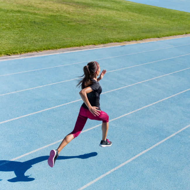 woman sprinting on track