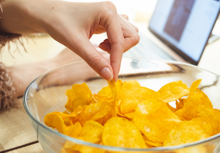 Woman eating chips.