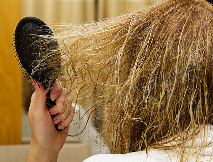 Hair tangled in brush.