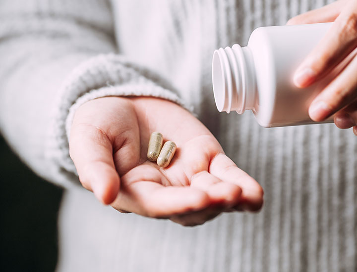 Woman taking vitamins.