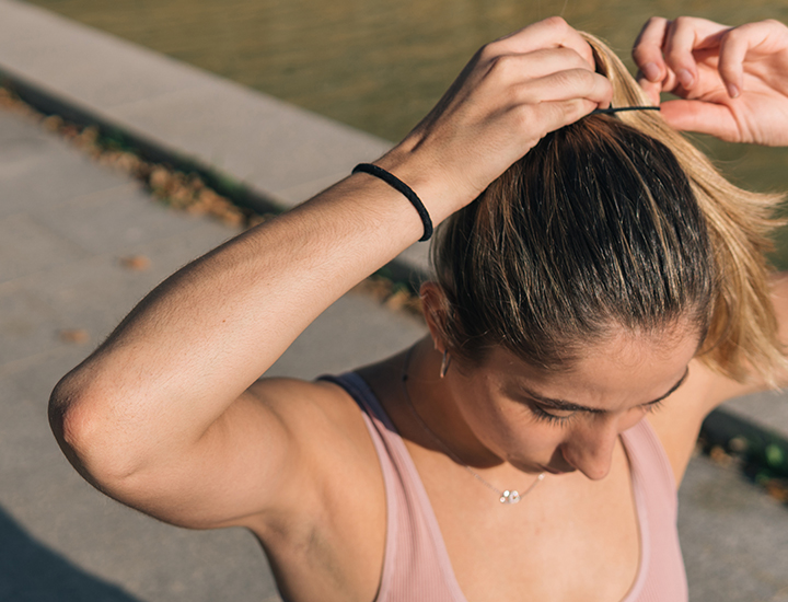 Woman typing ponytail.