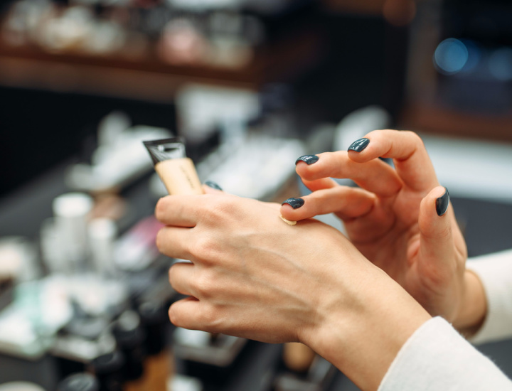 Woman applying foundation on hand