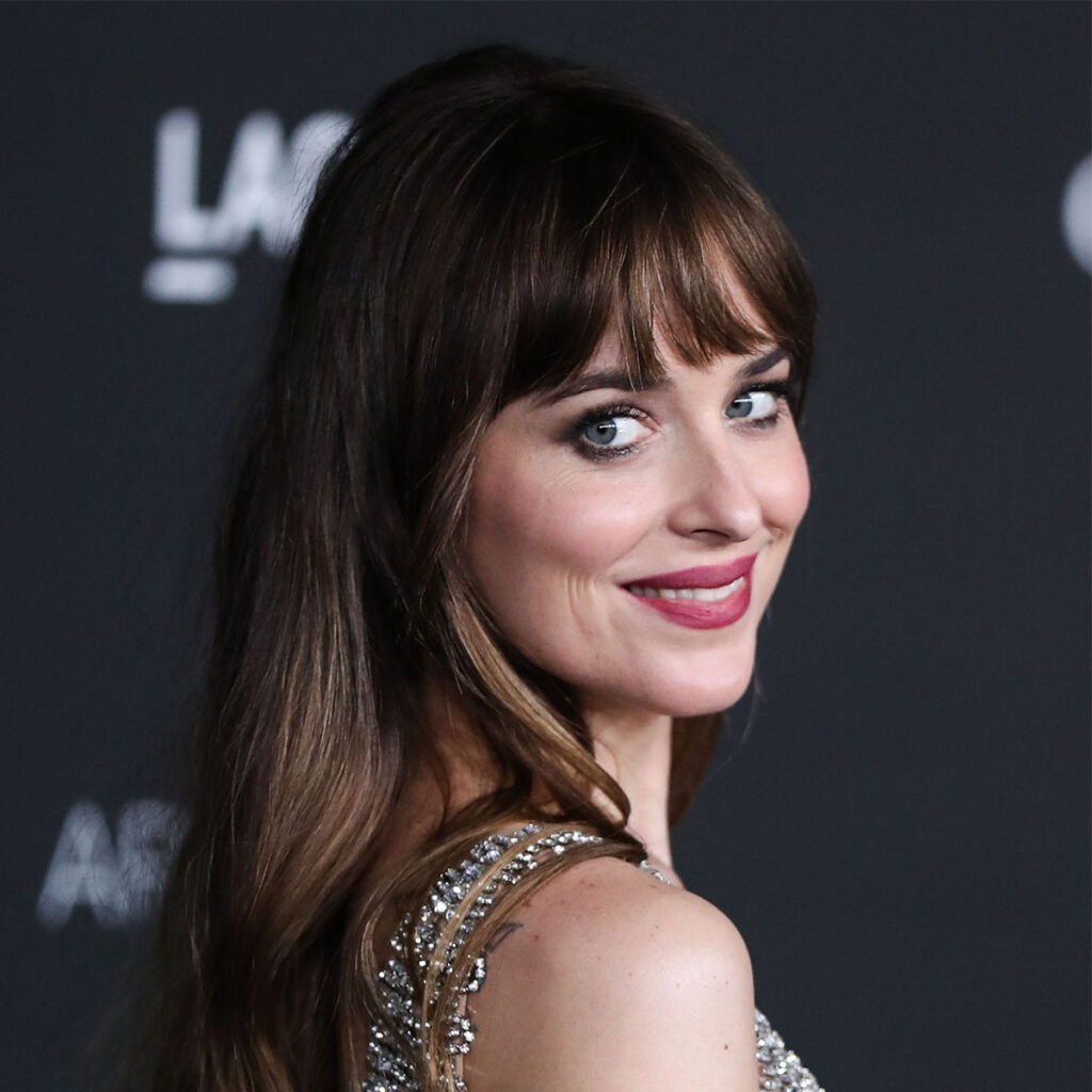 Dakota Johnson cuts a chic figure in a black summer dress and