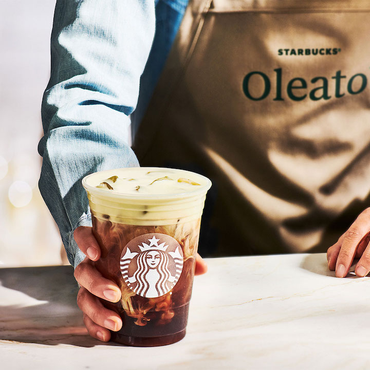 starbucks barista handing over oleato coffee