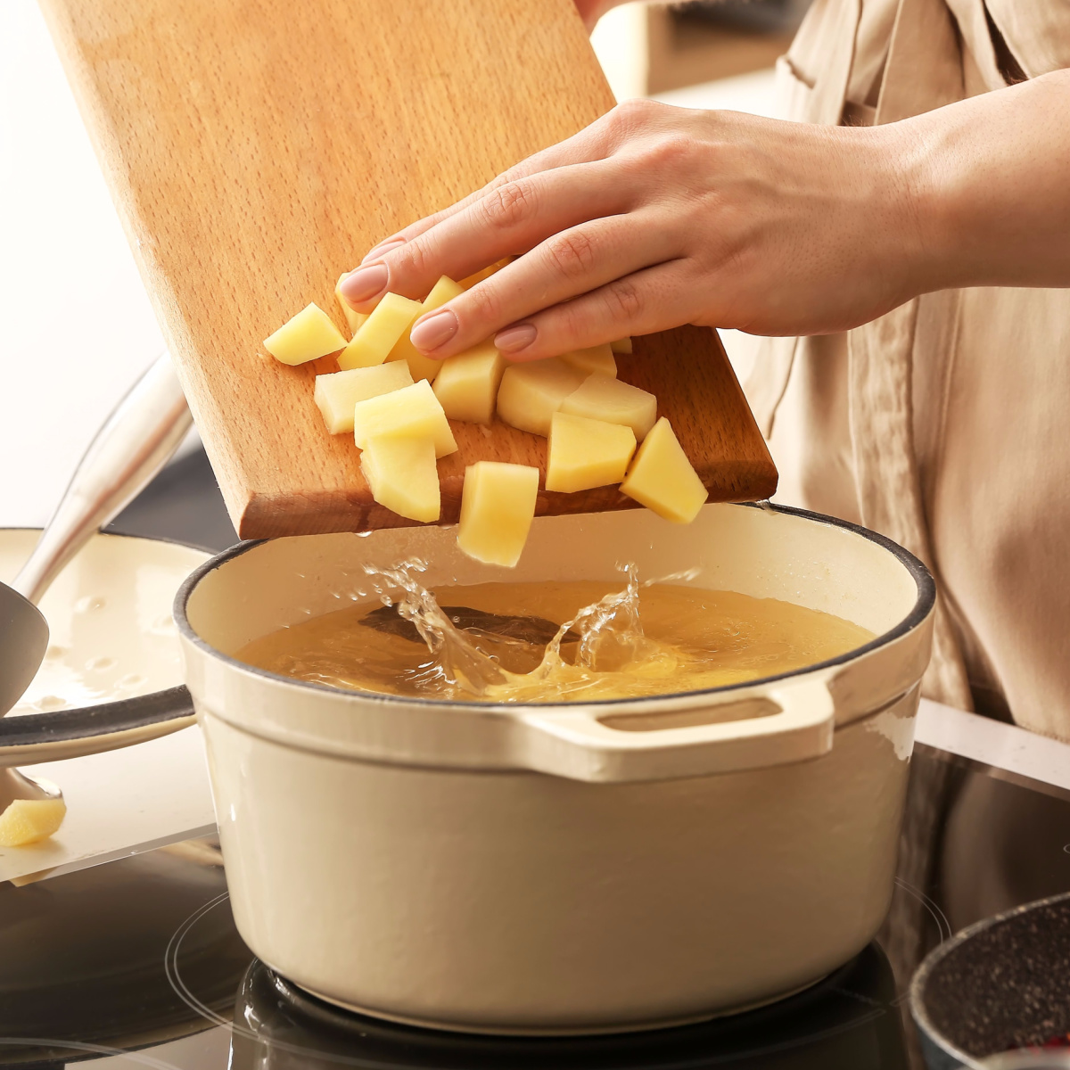 potatoes thrown in a pot of water