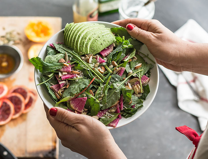 Woman holding a fresh salad