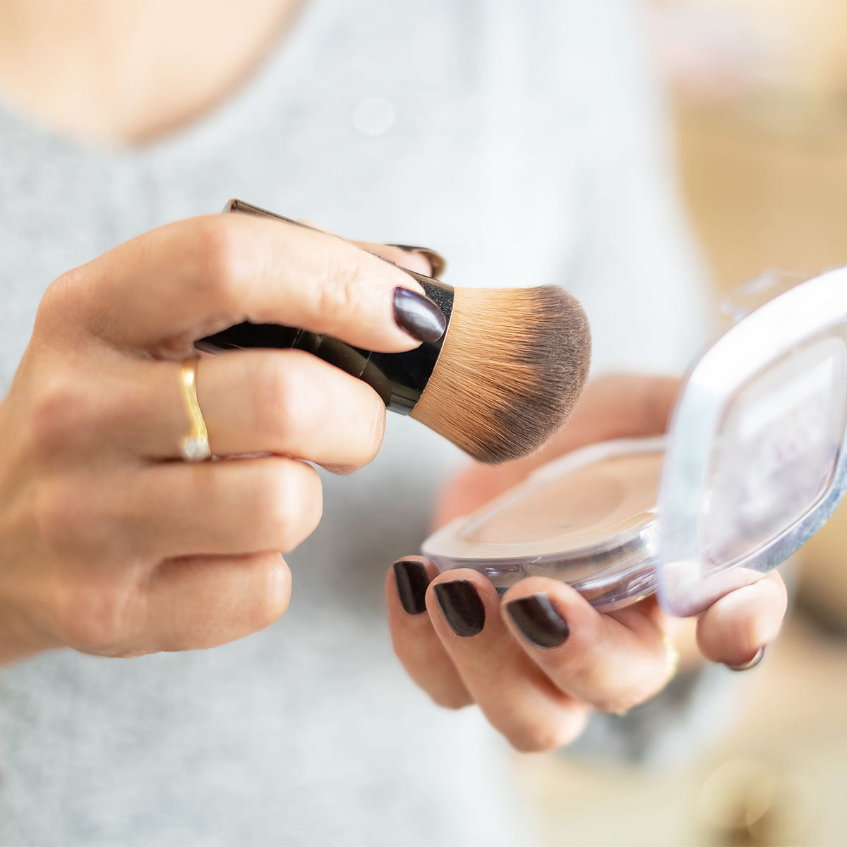 woman-holding-makeup-compact