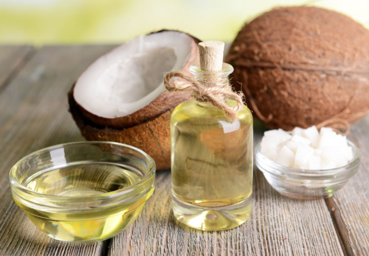 Container of coconut oil on a table