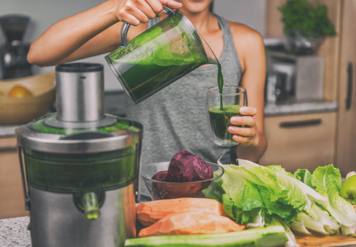 Woman juicing with a blender