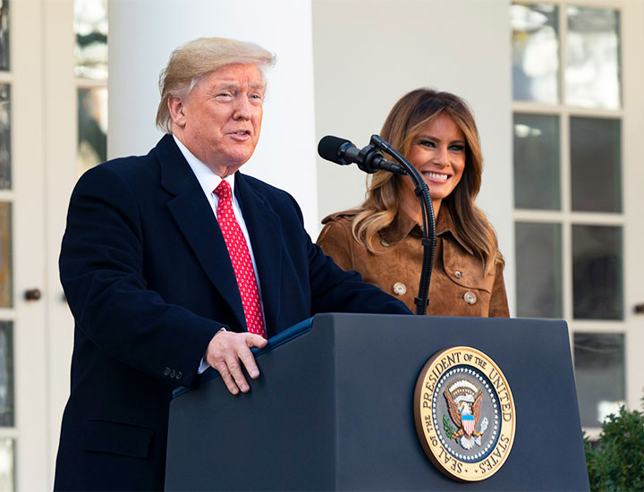 Donald Trump and Melania Trump standing together at podium