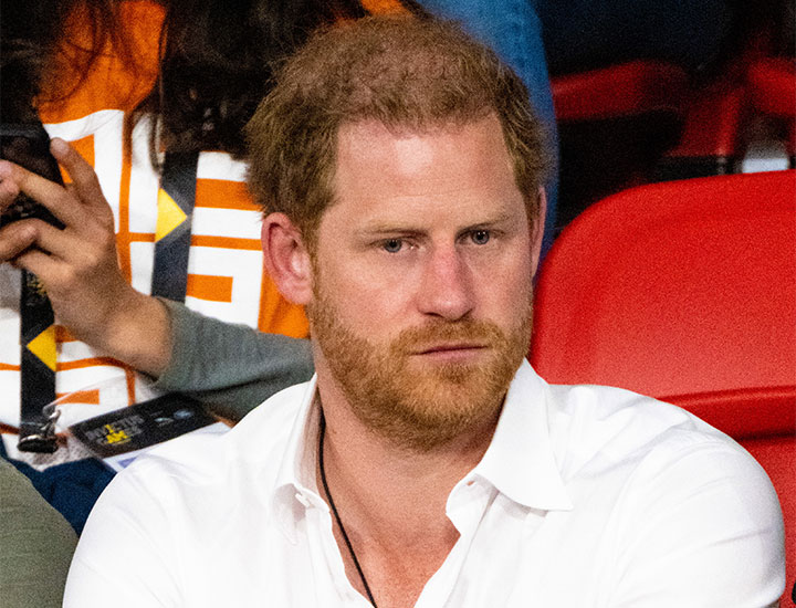 Prince Harry looking focused in white shirt