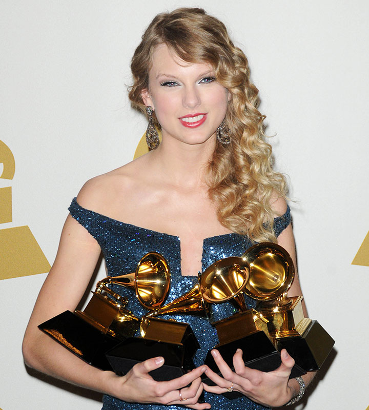 Taylor Swift 52nd Annual Grammy Awards holding awards