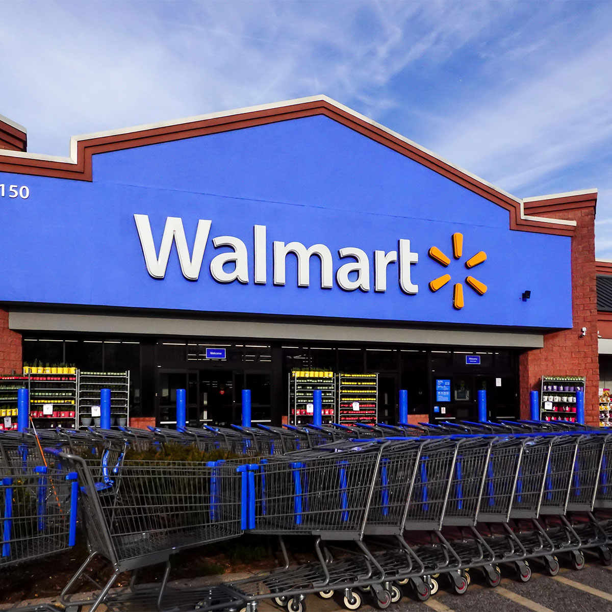 blue walmart storefront carts lined up in front of store