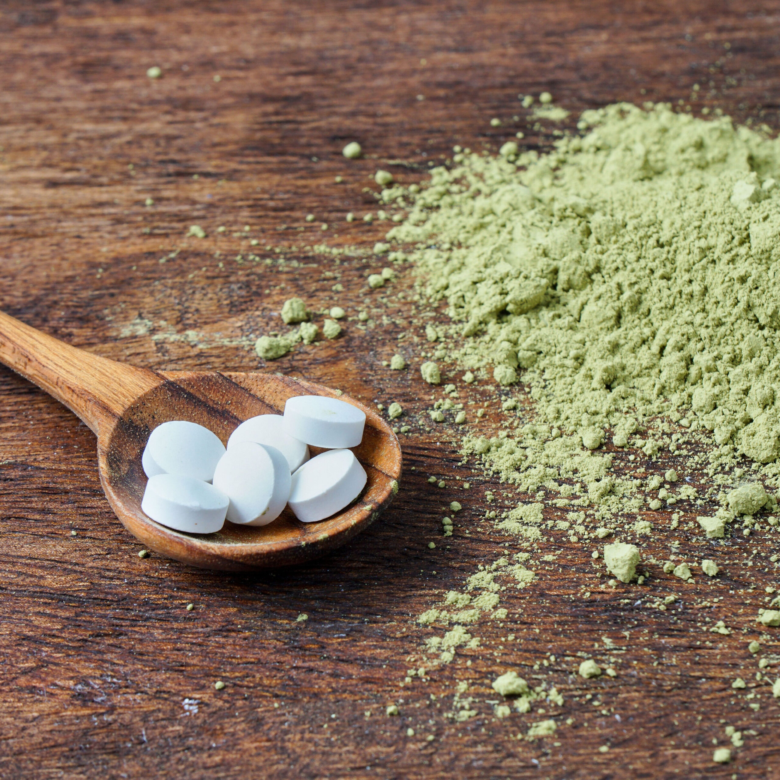 l theanine pills in spoon beside matcha powder