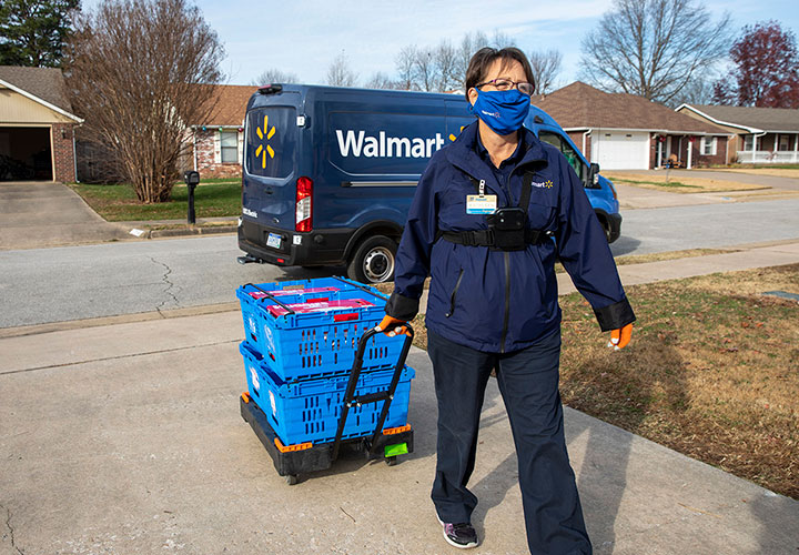 Walmart delivery person in driveway with order delivery