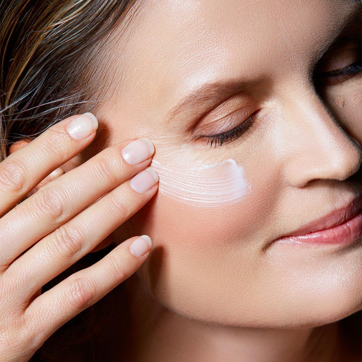 woman-applying-eye-cream