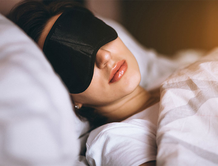 Woman asleep with an eye mask