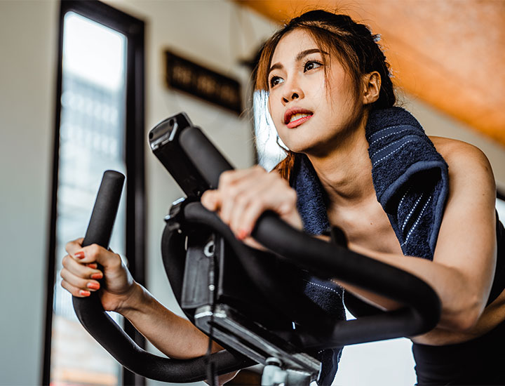 Woman doing cardio on a stationary bike