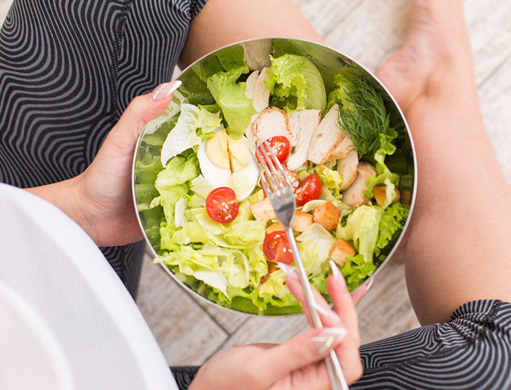 Woman eating a fresh salad