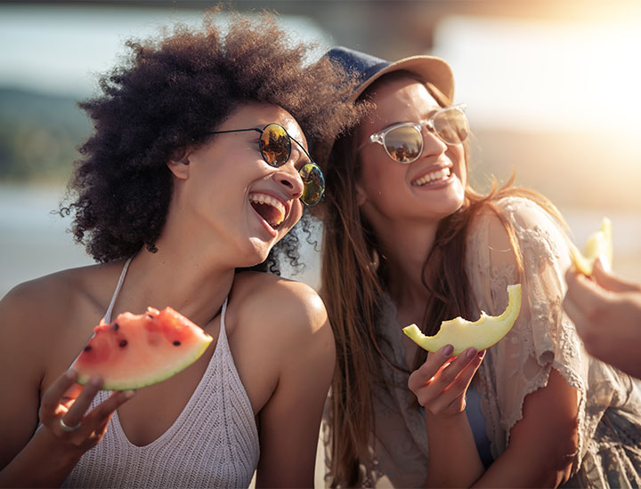 Women eating summer fruit