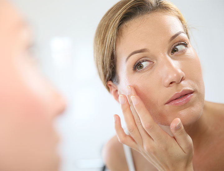 woman-looking-at-skin-mirror