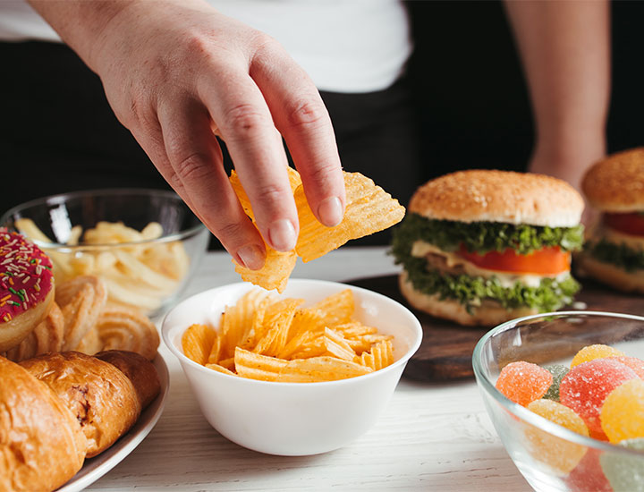 woman-reaching-for-junk-food