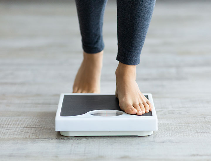 Woman stepping on a scale