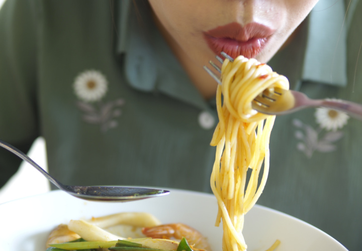 Woman eating pasta