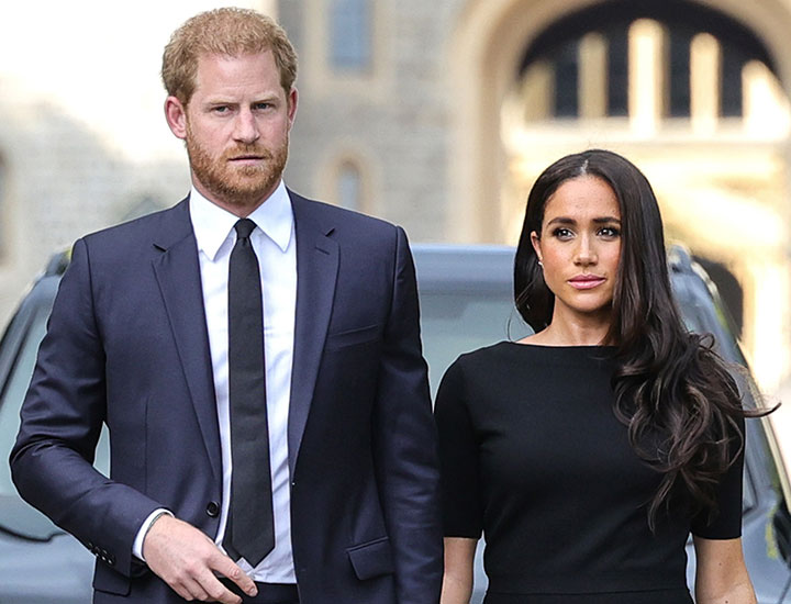 Prince Harry Meghan Markle looking at floral tributes at Windsor Castle