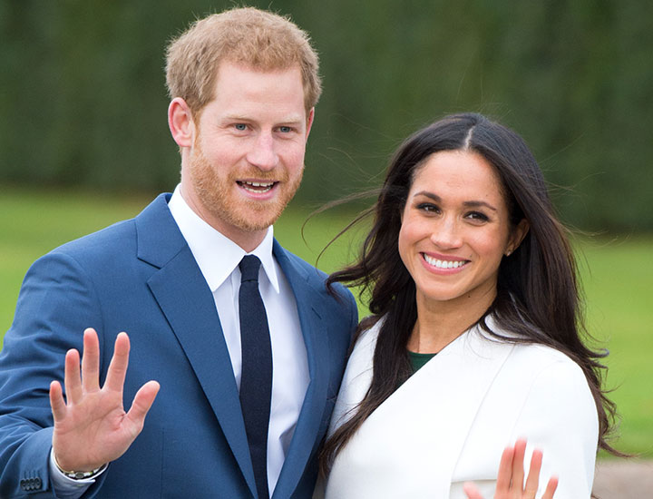 Prince Harry and Meghan Markle waving at their engagement announcement