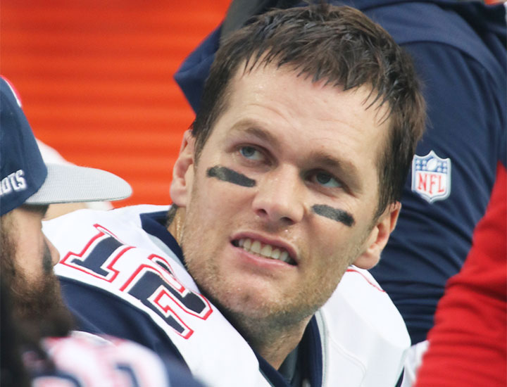 Tom Brady playing football for the New England Patriots