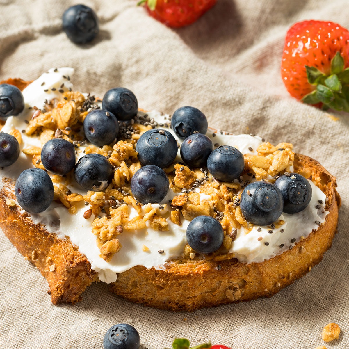 toast topped with creamy spread and blueberries