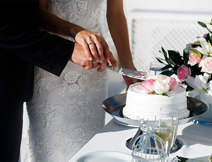 Couple cutting wedding cake