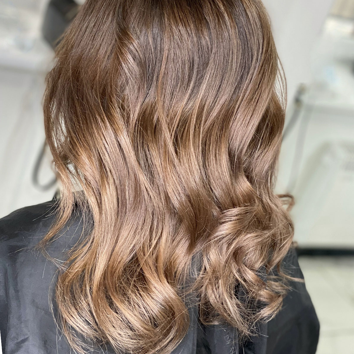 healthy shiny brown wavy curly hair salon back of head