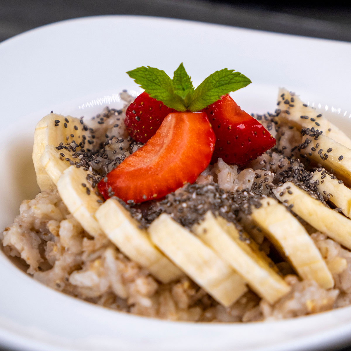 oatmeal topped with strawberries bananas and chia seeds