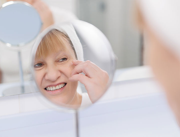 older-woman-applying-makeup